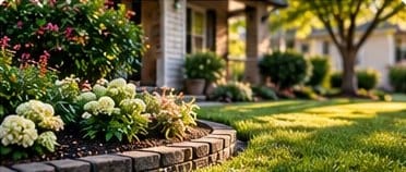 Landscaped garden bed beside a mowed lawn